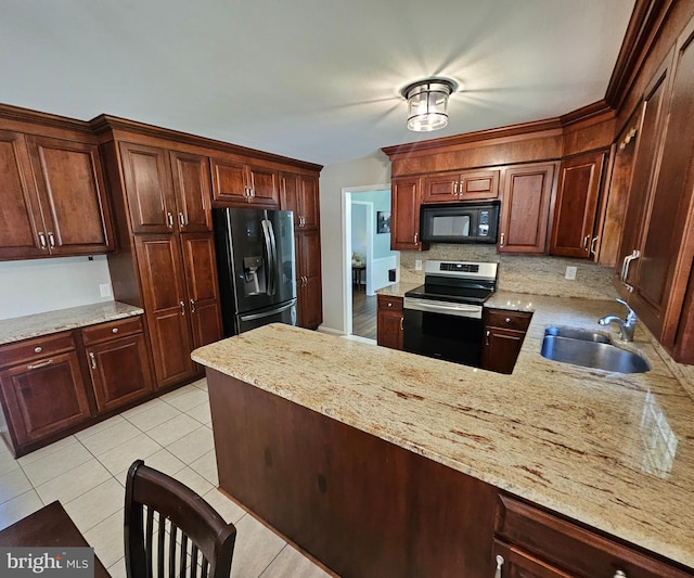 kitchen with decorative backsplash, a peninsula, light tile patterned flooring, a sink, and black appliances