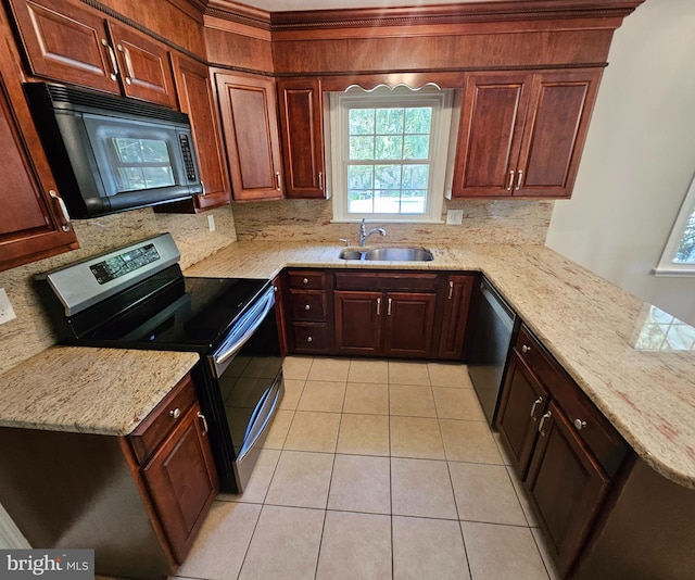 kitchen featuring a sink, stainless steel appliances, a peninsula, light tile patterned floors, and backsplash