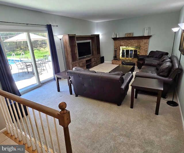 carpeted living room featuring a brick fireplace