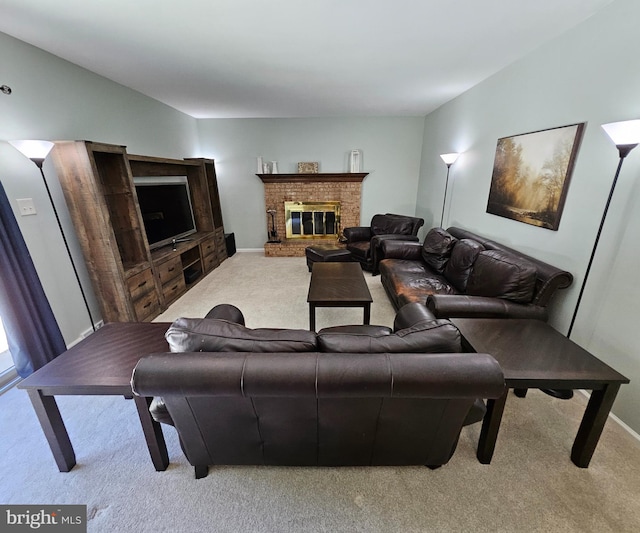 carpeted living area featuring baseboards and a brick fireplace