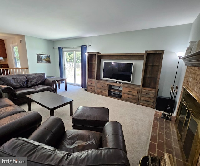 living room featuring dark colored carpet and a brick fireplace