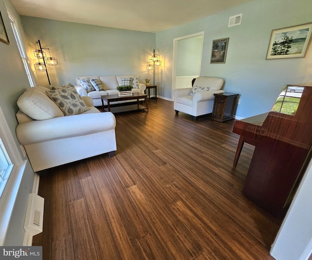 living room featuring wood finished floors and visible vents