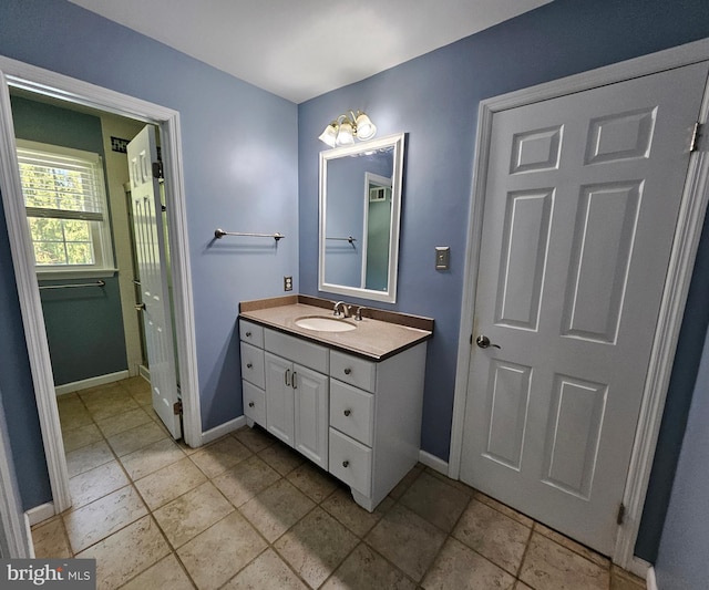 bathroom with vanity and baseboards