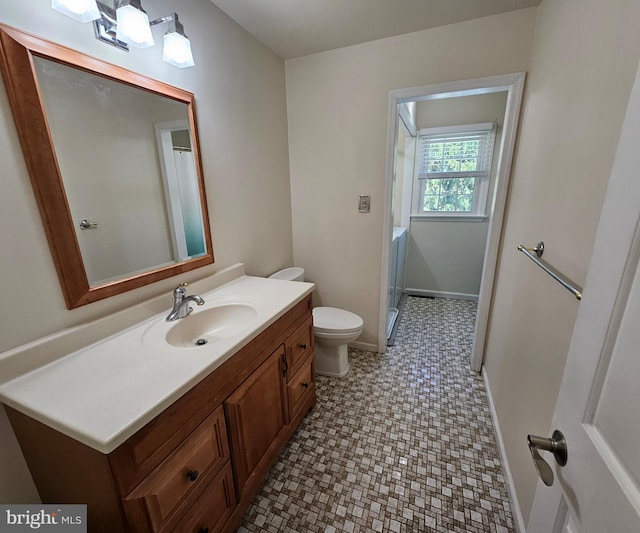 full bathroom featuring vanity, toilet, baseboards, a shower with shower curtain, and tile patterned floors