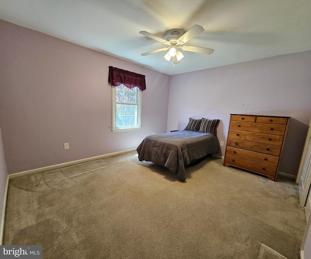 bedroom featuring baseboards, a ceiling fan, and light colored carpet
