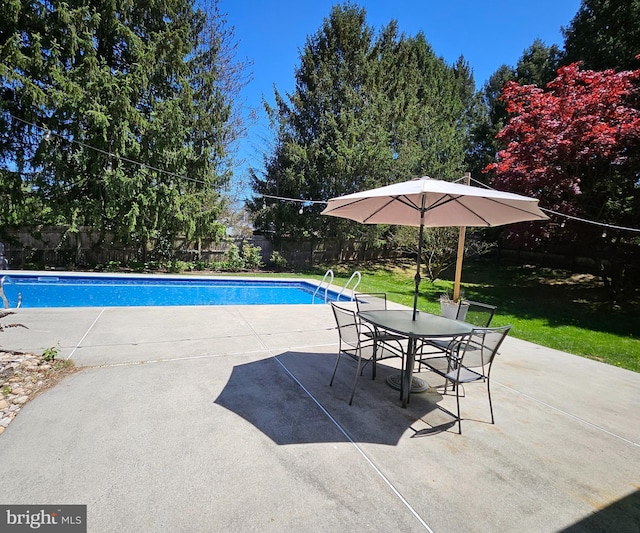 view of pool featuring a lawn, a patio area, and a fenced in pool