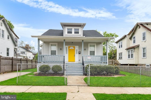 3026 Rosalind Ave, Baltimore, MD 21215 - bungalow-style house featuring a porch, a front lawn, and a fenced front yard