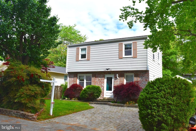 1920 Potomac Rd, Edgewater, MD 21037 - colonial home with brick siding, fence, and a front lawn