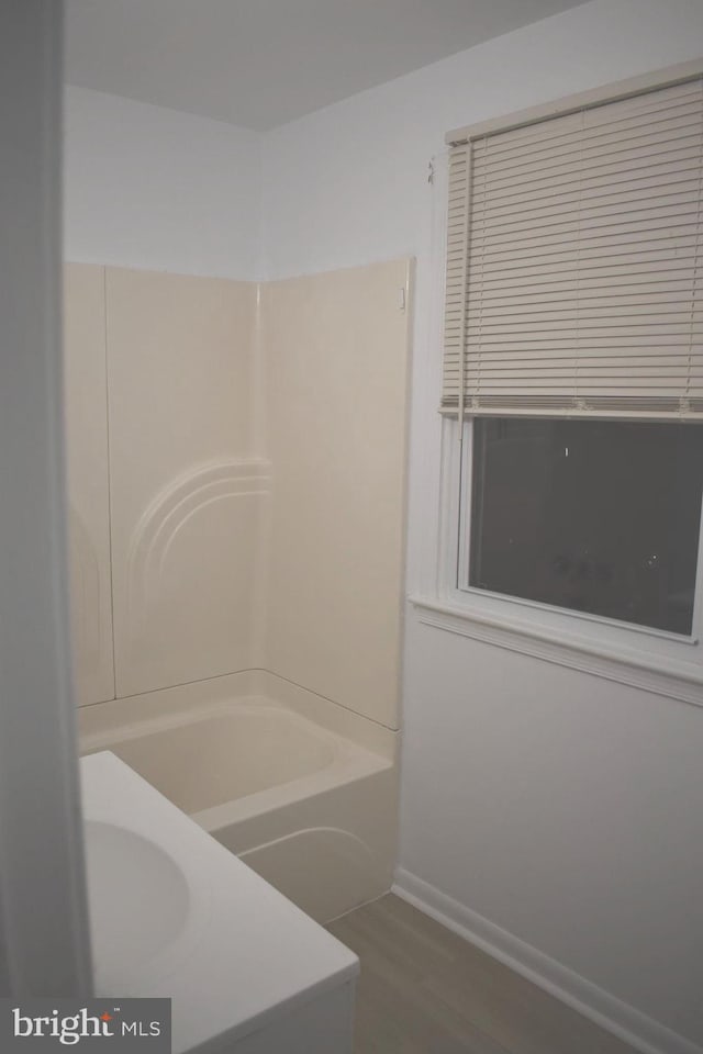 1920 Potomac Rd, Edgewater, MD 21037 - bathroom featuring baseboards, shower / bathtub combination, wood finished floors, and toilet