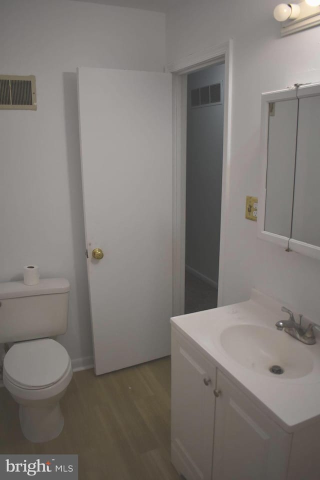 1920 Potomac Rd, Edgewater, MD 21037 - bathroom with toilet, visible vents, wood finished floors, and vanity