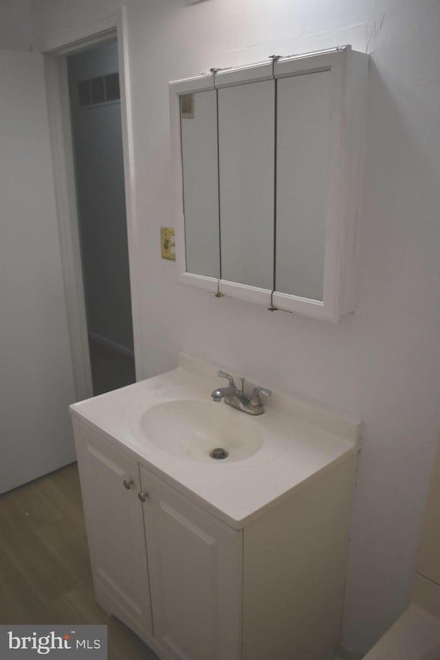 1920 Potomac Rd, Edgewater, MD 21037 - bathroom featuring vanity, wood finished floors, and visible vents