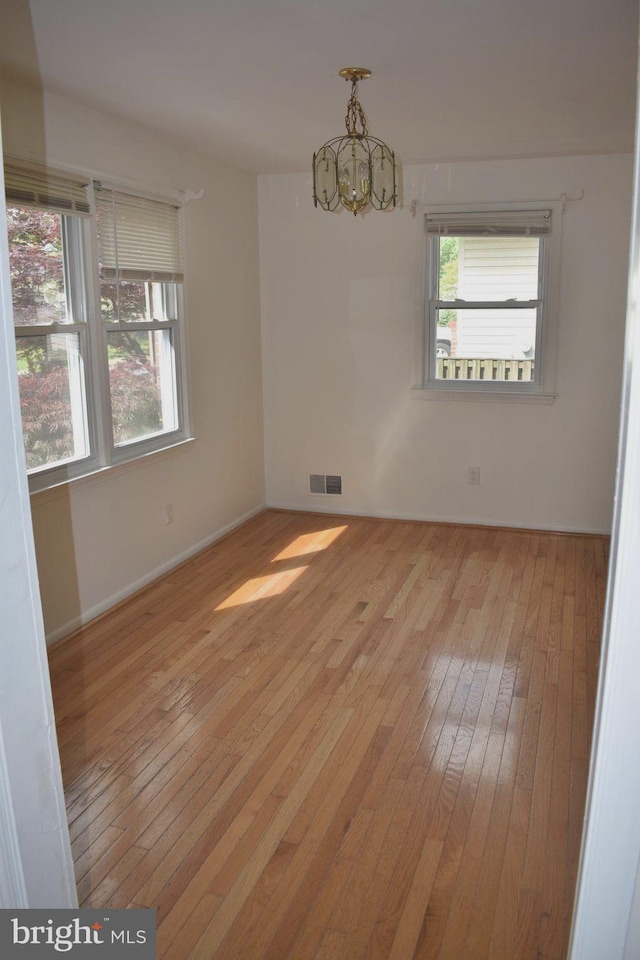 1920 Potomac Rd, Edgewater, MD 21037 - empty room featuring baseboards, wood-type flooring, a chandelier, and visible vents