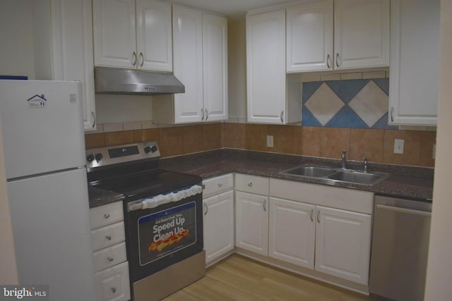 1920 Potomac Rd, Edgewater, MD 21037 - kitchen featuring decorative backsplash, a sink, under cabinet range hood, stainless steel appliances, and white cabinetry
