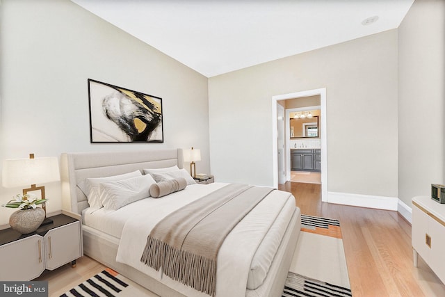2600 Pennsylvania Ave NW Unit 601/6D, Washington, DC 20037 - bedroom featuring light wood-style flooring, baseboards, a sink, and connected bathroom