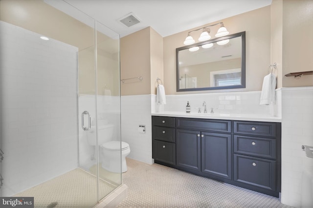 2600 Pennsylvania Ave NW Unit 601/6D, Washington, DC 20037 - full bath with tile walls, vanity, toilet, a stall shower, and a wainscoted wall