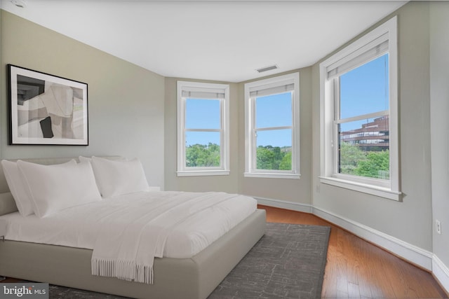 2600 Pennsylvania Ave NW Unit 601/6D, Washington, DC 20037 - bedroom with multiple windows, baseboards, and wood finished floors
