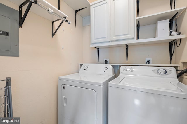 laundry area with cabinet space, washing machine and dryer, and electric panel