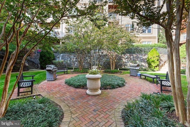 view of community featuring a patio and stairway