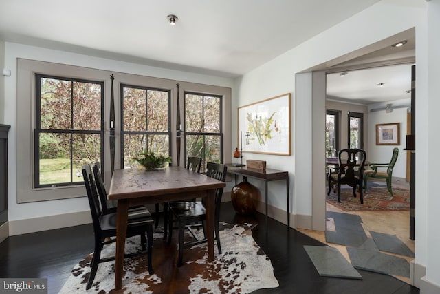 dining space featuring baseboards and wood finished floors
