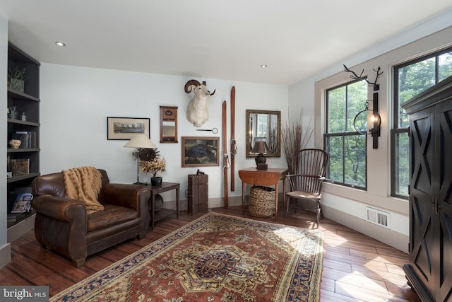 sitting room featuring hardwood / wood-style floors and recessed lighting
