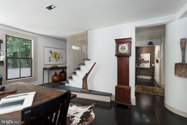 foyer featuring stairs, dark wood-style flooring, and baseboards