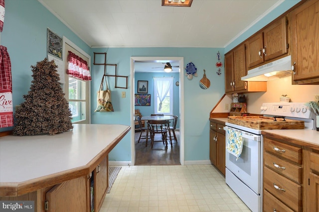 kitchen with white range with electric stovetop, brown cabinetry, a ceiling fan, light floors, and under cabinet range hood