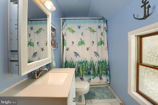 full bathroom featuring tile patterned flooring, lofted ceiling, toilet, and vanity