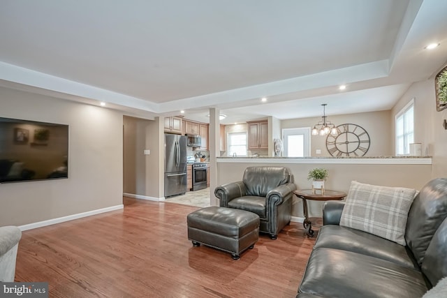 20 Aspen Dr, Pennsville, NJ 08070 - living room featuring recessed lighting, baseboards, an inviting chandelier, and light wood-type flooring
