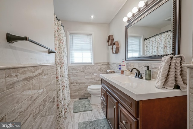 20 Aspen Dr, Pennsville, NJ 08070 - full bathroom featuring tile walls, a wainscoted wall, vanity, and toilet