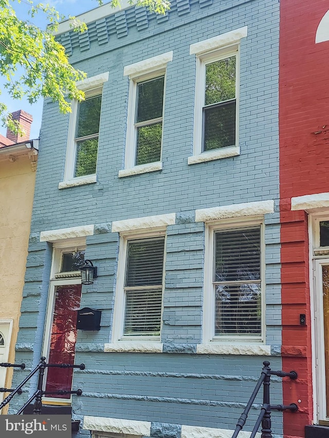 view of property exterior with brick siding