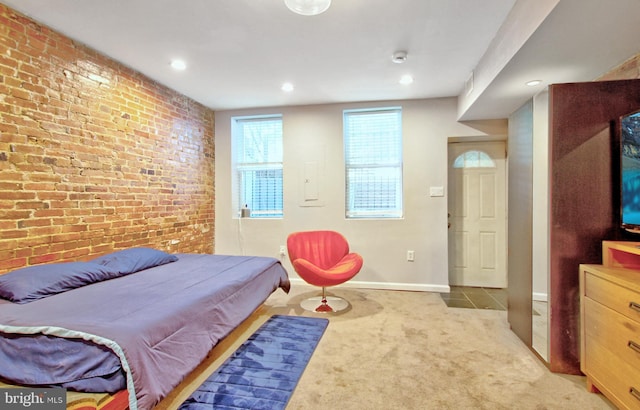 carpeted bedroom featuring recessed lighting, brick wall, and baseboards