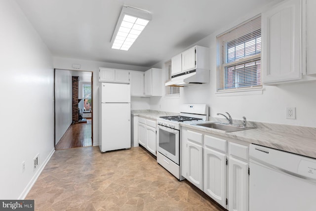 3403 Toone St, Baltimore, MD 21224 - kitchen with white appliances, under cabinet range hood, a sink, and healthy amount of natural light