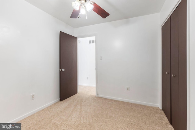 3403 Toone St, Baltimore, MD 21224 - unfurnished bedroom with light colored carpet, a closet, baseboards, and a ceiling fan
