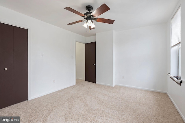 3403 Toone St, Baltimore, MD 21224 - unfurnished bedroom featuring light carpet, baseboards, and a ceiling fan