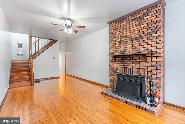 3403 Toone St, Baltimore, MD 21224 - unfurnished living room with a fireplace, a ceiling fan, wood finished floors, and baseboards
