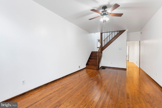 3403 Toone St, Baltimore, MD 21224 - unfurnished living room with ceiling fan, wood finished floors, stairway, and baseboards