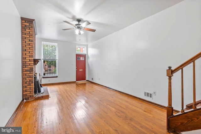3403 Toone St, Baltimore, MD 21224 - unfurnished living room with ceiling fan, wood-type flooring, stairway, and baseboards