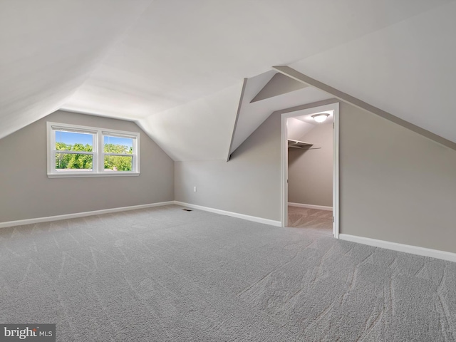 bonus room with baseboards, carpet, and vaulted ceiling