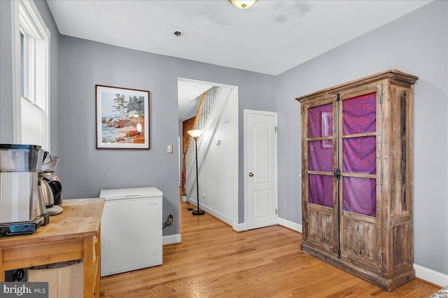 home office featuring baseboards and light wood-style flooring