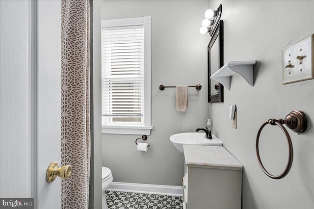 full bath with toilet, baseboards, tile patterned floors, and vanity