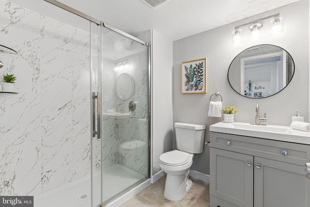 full bath featuring toilet, a marble finish shower, vanity, and baseboards