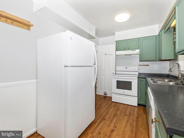 201 N 2nd St, Woodsboro, MD 21798 - kitchen with white appliances, green cabinets, under cabinet range hood, a sink, and dark countertops