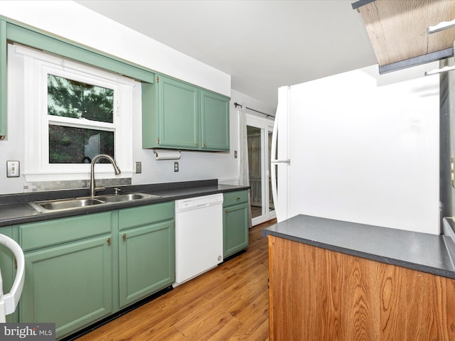 201 N 2nd St, Woodsboro, MD 21798 - kitchen with dishwasher, a sink, dark countertops, light wood-type flooring, and green cabinetry
