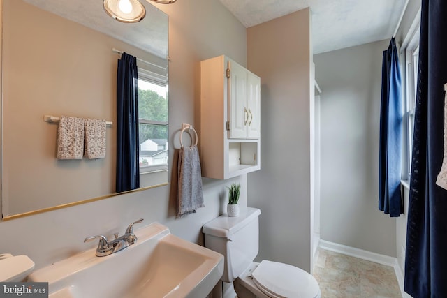 15926 Uppsala Ct, Woodbridge, VA 22191 - bathroom with a sink, toilet, and baseboards