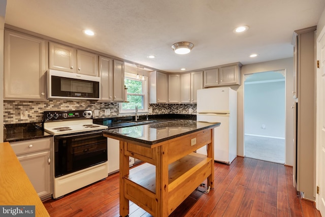 15926 Uppsala Ct, Woodbridge, VA 22191 - kitchen with electric stove, freestanding refrigerator, dark wood-type flooring, decorative backsplash, and a sink
