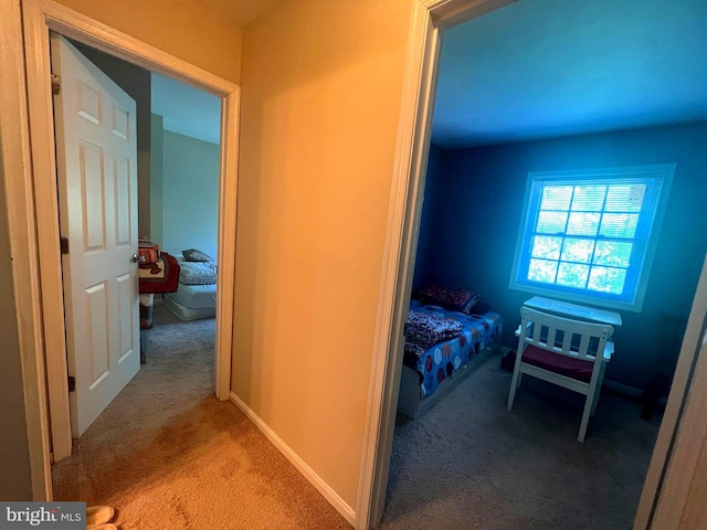 hallway featuring light carpet