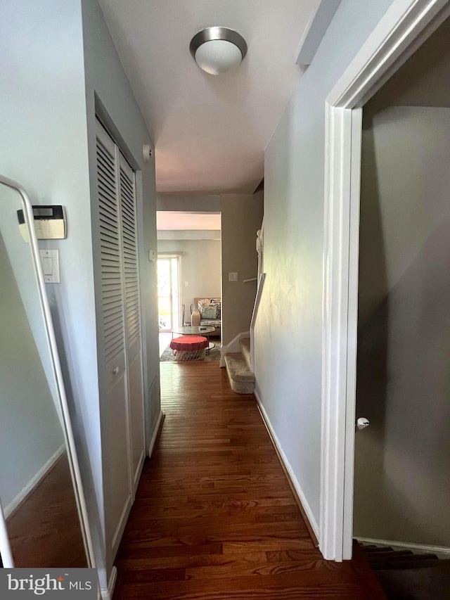 hallway with baseboards and dark wood finished floors