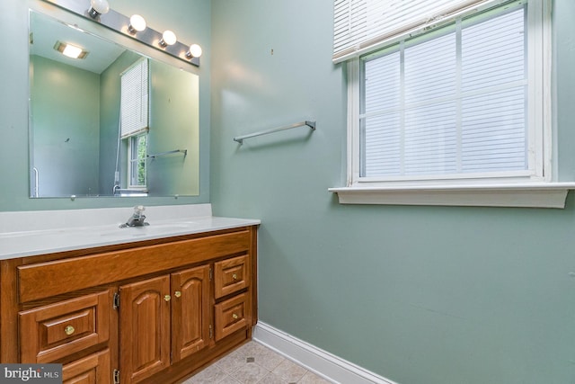 bathroom featuring baseboards, tile patterned flooring, and vanity