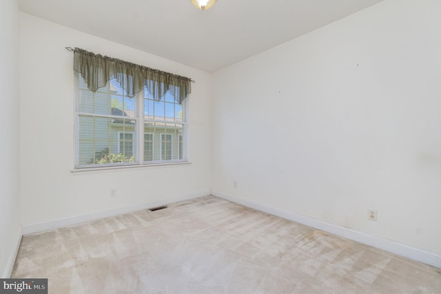 unfurnished room featuring carpet floors, baseboards, and visible vents