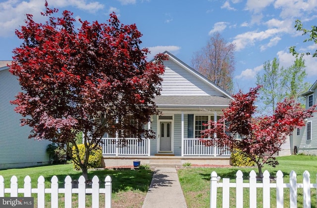 view of front of property with a porch, fence, and a front yard